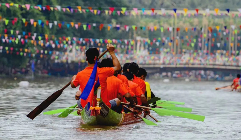 people boat rowing during water festival